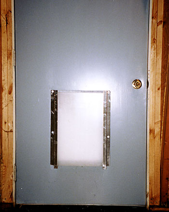 dog door closing panel installed in door
